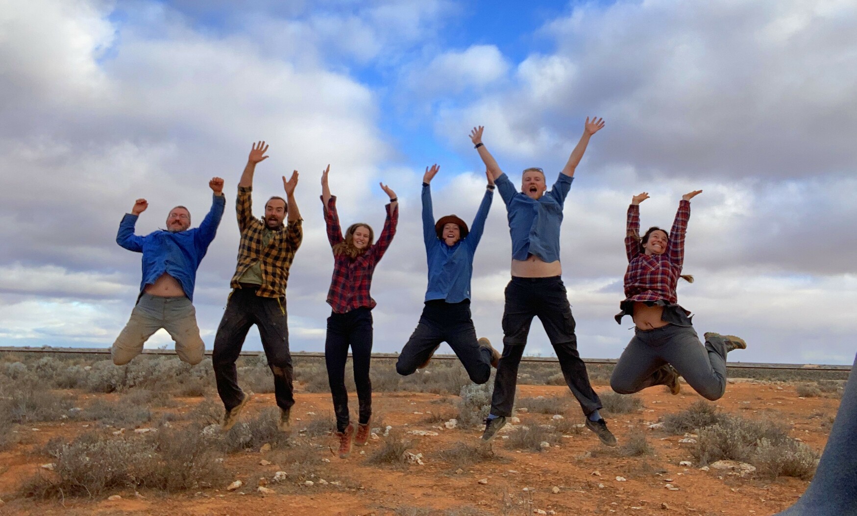 Happy team posing in front of the Trans-Australian Railway - credit: Raiza Quintero